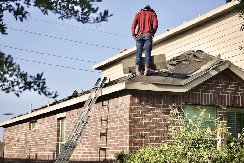 Professional roofer working on a residential roof in Forebay